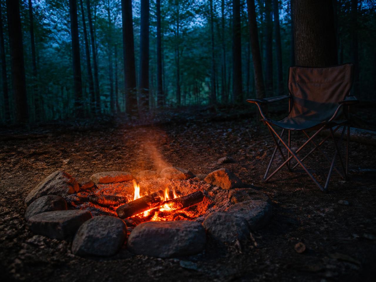 Low campfire in a stone ring at dusk