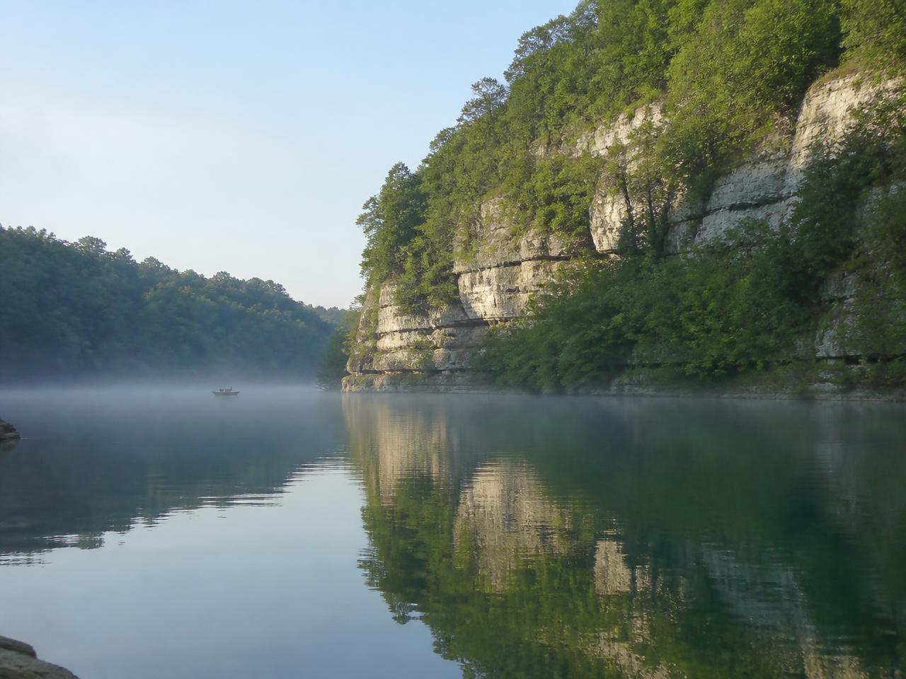 Misty morning cove on Lake Cumberland below wooded bluffs
